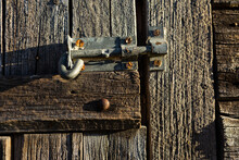 Old Weather Worn Wooden Stables With Latch Keeping Door Closed