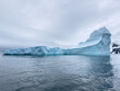© Vladimir Drozdin - A huge high breakaway glacier drifts in the southern ocean off the coast of Antarctica at sunset, the Antarctic Peninsula, the Southern Arctic Circle, azure water, cloudy weather
