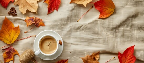 Canvas Print - Coffee cup on linen background with autumn leaves. Fall concept, copy space, flat lay.