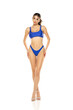 © vladimirfloyd - Young beautiful brunette woman in blue bikini swimsuit posing on a white background.