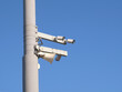 Traffic control road cameras mounted on the pole against clear blue cloudless sky