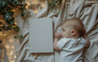 maquete em branco do diário de capa dura fechado, deitado na cama, um bebê fofo  está dormindo ao lado dele, vista de cima para baixo