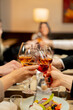 © Guys Who Shoot - colleagues at work are sitting in a restaurant, celebrating the conclusion of a new agreement toasts with glasses of wine close-up