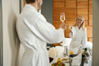 © Svitlana - Newlyweds in bathrobes celebrate in a hotel room