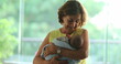 © Marco - Happy Grand-mother calming and holding newborn baby in arms