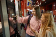 © Nomad_Soul - Two preteen girls using modern self-service kiosk at shopping mall