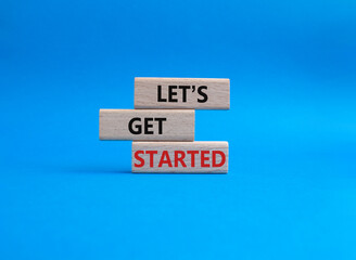 Wall Mural - lets get started symbol. concept words lets get started on wooden blocks. beautiful blue background.
