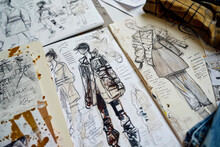 Fashion design sketches spread on a creative workspace Generative AI image