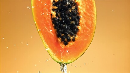 Poster - Fresh tropical papaya with drops and splashes of water. Filmed on a high-speed camera at 1000 fps. High quality FullHD footage