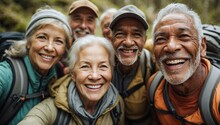 Cheerful Elderly Hikers Taking A Group Selfie In The Forest, Showcasing Wide Smiles And Outdoor Gear.