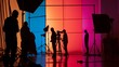 Silhouetted film crew in colorful studio setup, depicting the vibrant atmosphere of a professional shoot