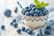 Light Spring Milk Drink With Striped Straw, Blueberries In A Bowl On White Wooden Table, Copy Space