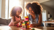 © Serhii - African American Mother and Daughter Building Colorful Wooden Block Towers at Home