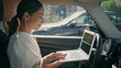 © stockbusters - Smart lady boss car looking laptop sitting at front seat closeup. Woman working