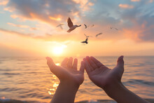 Hands Open Palm Up Worship With Birds Flying Over Calm Water Sunset Background. Concept Of Praying For Blessing From God. 