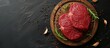 Raw beef fillet on wooden plate with seasoning, surrounded by peppercorns, on black background.
