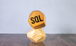 © Uladzislau - Wooden cubes on a brown background with the text 'SQL' represent the concept of 'Sales Qualified Lead'.