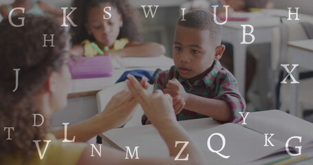 Poster - Image of letters over diverse female teacher and schoolboy signing in class