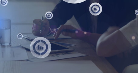 Poster - Digital icons floating against mid section of businessman and businesswoman discussing at office