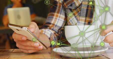 Poster - Globe of digital icons against mid section of man using smartphone and drinking coffee at a cafe