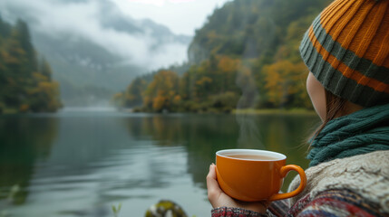 Wall Mural - Drinking tea in nature by a serene lake in the morning. 