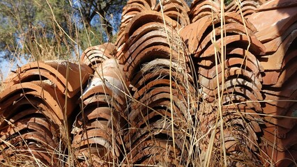 Hundreds of antique roof tiles piled in a row ready to be used for a new home.