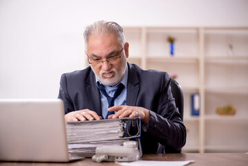 Wall Mural - Old male employee and too much work in the office