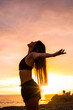 Portrait of active young woman enjoying the sunset outdoor during sport exercises - concept of happy people doing activity outdoor - success and results with coloured scenic place