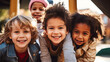 Group of happy diverse children smiling and huddling together outdoors
