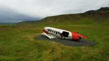 Tourist visits plane wreckage (DC-3 Airplane) in Eyvindarholt, Iceland