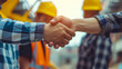 © stocker - Diverse engineering team comes together, shaking hands in a show of cooperation and commitment to successfully complete a project.