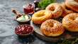 Freshly baked bagels with a decadent spread of smooth cream cheese and luscious jam on a rustic, homemade bread background. Indulge in this irresistible combination of savory and sweet flavo
