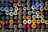 Fototapeta Młodzieżowe - Background of the reels with colorful threads