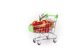 © yta - Grocery cart filled with Italian food, pasta and tomato, white background, supermarket purchase