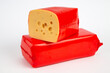 Two Cheeses in red shrink bag withcross-section of the cheese shown on white 