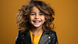 little cute girl in a black leather biker jacket smiling on a color background in the studio, children, child, childhood, teenager, kid, schoolgirl, fashion, style, rock, space for text, rocker, rebel