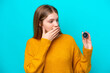 Teenager Russian girl holding compass isolated on blue background with surprise and shocked facial expression