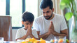 Indian family on dining table doing prayer before eating