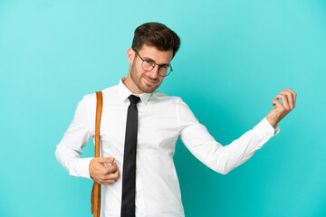 Wall Mural - Business man over isolated background making guitar gesture