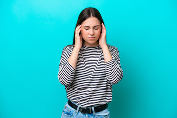 Wall Mural - Young caucasian woman isolated on blue background with headache