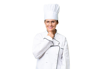 Wall Mural - Middle-aged chef woman over isolated background with glasses and smiling