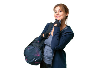 Wall Mural - Middle-aged sport woman with sport bag over isolated background smiling