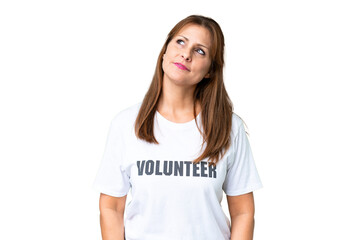 Wall Mural - Middle age volunteer woman over isolated background thinking an idea while looking up