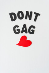 Poster - don't gag and wooden heart painted red on paper