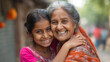 © PrabhjitSingh - Happy Indian family: Woman and grandmother embrace granddaughter in urban setting