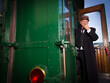 Retro train conductor in antique train