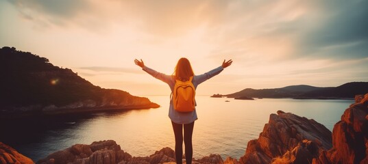 Confident woman with backpack with arms up relaxing at sunset seaside during a trip , traveler enjoying freedom in serene nature landscape