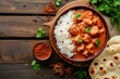Spicy chicken tikka masala with rice and naan bread.