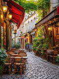 Fototapeta Uliczki - Traditional Parisian street scene with cafe tables in France. Charming city view of Paris.