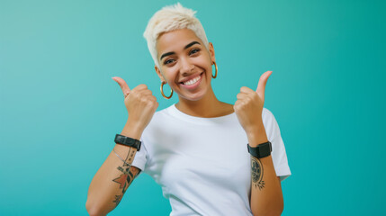 Canvas Print - cheerful young woman with short blonde hair and tattoos is pointing to both sides with a big smile, against a vibrant turquoise background